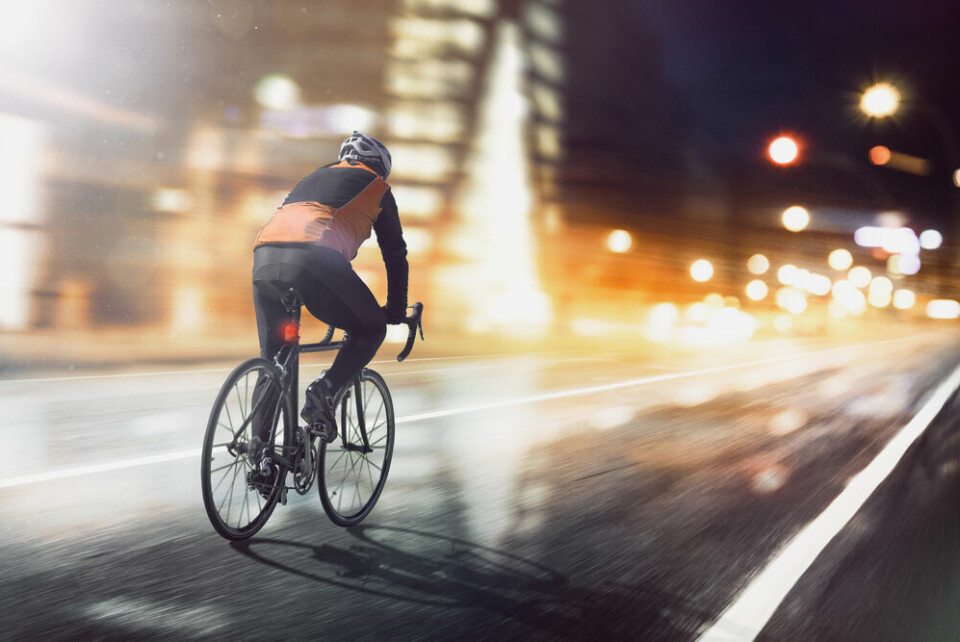 A cyclist riding on a road at night