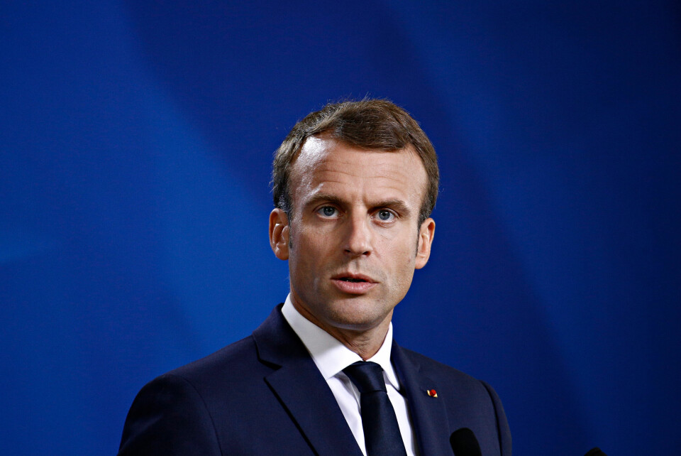 A photo of President Macron against a dark blue background