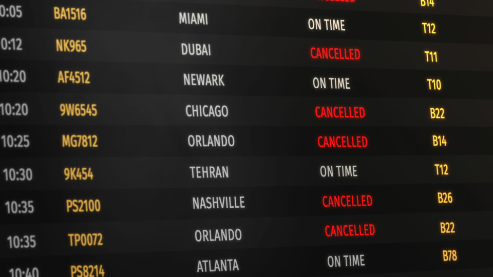 An airport information board with red letters marking Cancelled for every flight