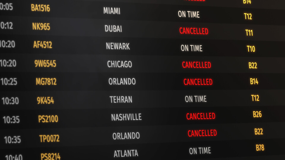 An airport information board with red letters marking Cancelled for every flight