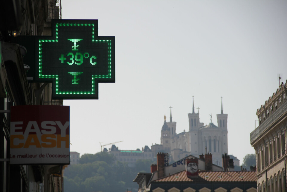 A view of a pharmacy thermometer in Lyon, France, reading 39C