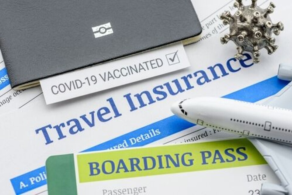 William Potter / Shutterstock A passport, boarding pass, travel insurance policy, Covid certificate, model of coronavirus and a plane on a table