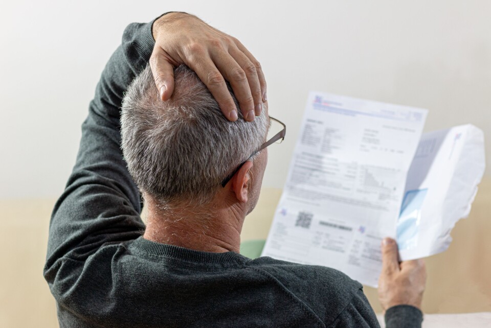 Older man looking at a bill