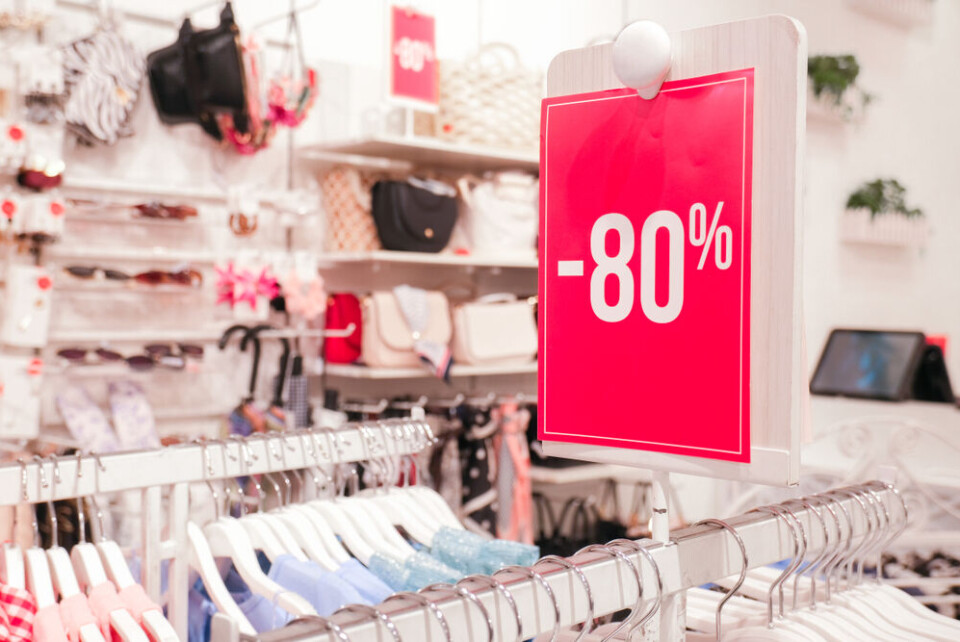 Natali Kuzina / Shutterstock A sign in a shop with -80% discount