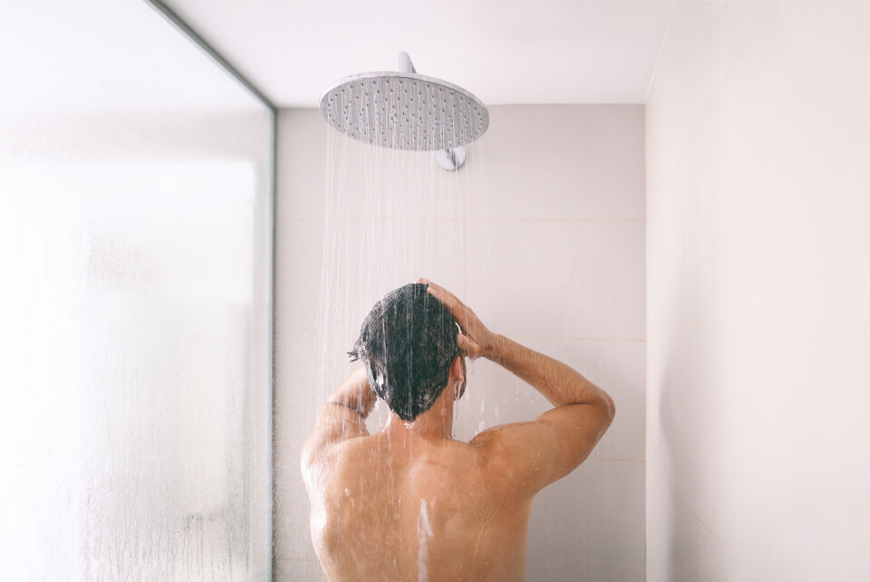 Maridav / Shutterstock A photo of a man having a shower in a modern shower cubicle