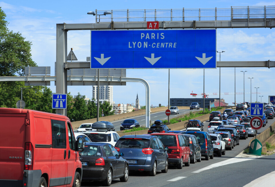 A photo of traffic jams on a motorway in France under a sign saying PARIS and LYON Centre