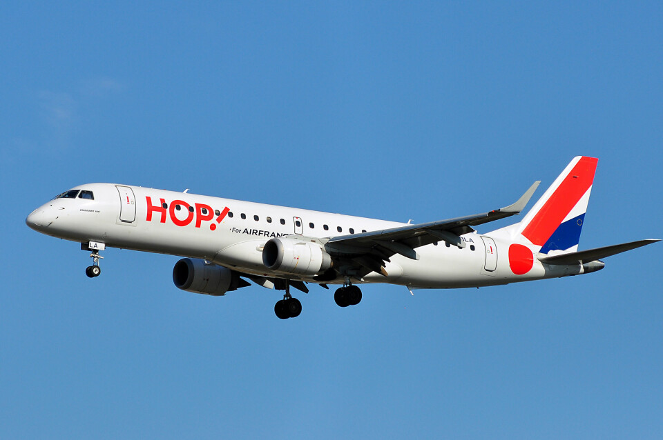 An Hop plane flying in a blue sky