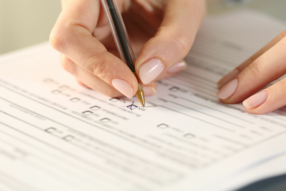 Woman's hand writing on questionnaire