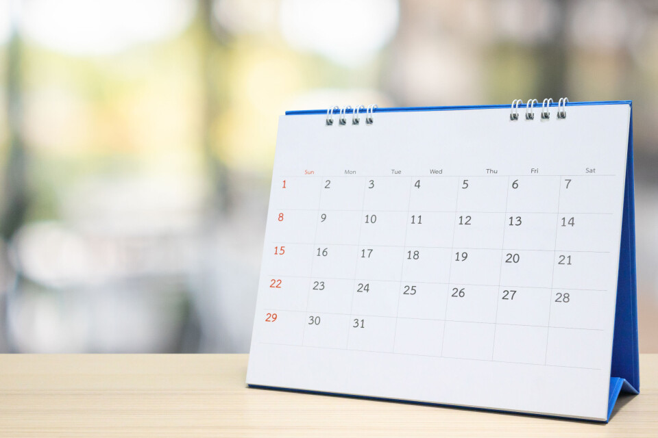 A photo of a calendar placed on a wooden desk