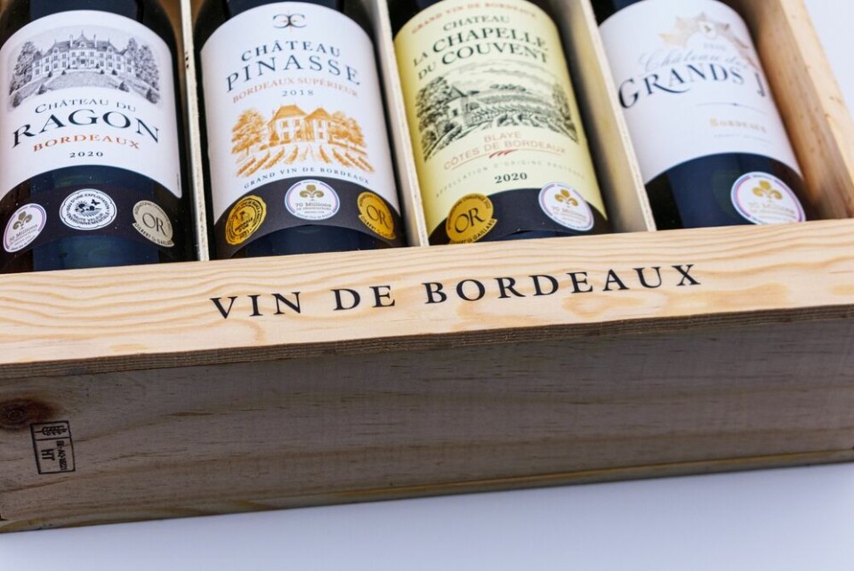 A box of assorted Bordeaux wine bottles