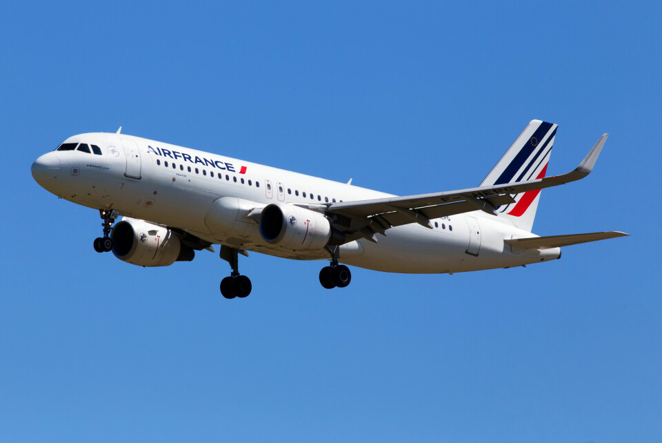 A photo of an Air France plane flying against a blue sky