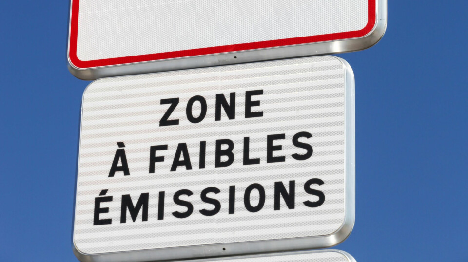 A photo of a low emission zone (zone à faibles émissions) sign in France against blue sky