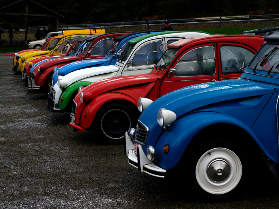 A row of vintage French models of the Citroen 2CV