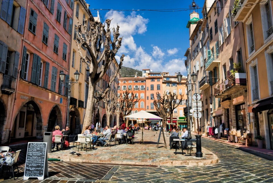 A touristic square lined with shops and cafés in Grasse