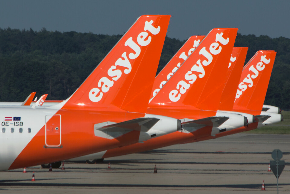 A row of EasyJet planes grounded on the tarmac at an airport