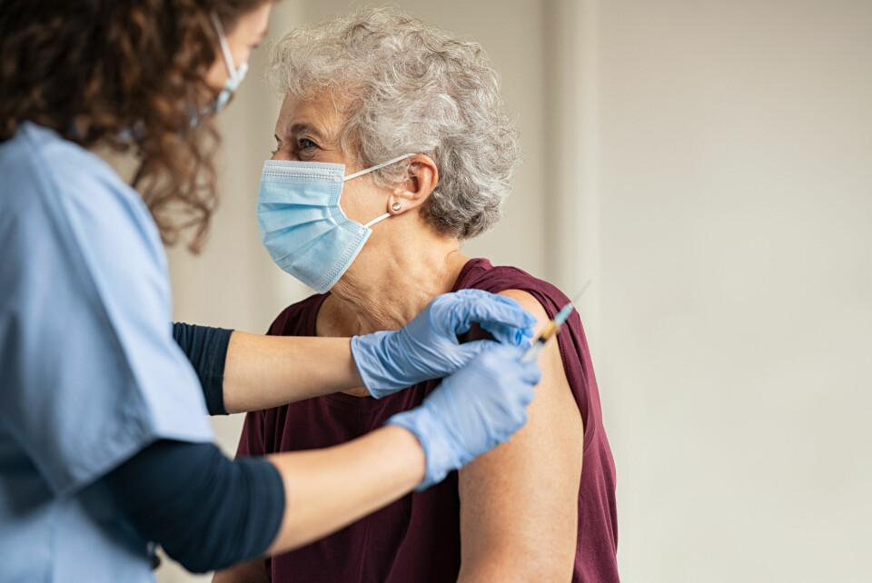 A photo of an older woman getting a Covid vaccination