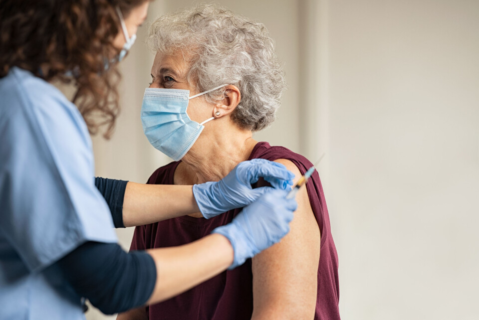 A photo of an older woman getting a Covid vaccination