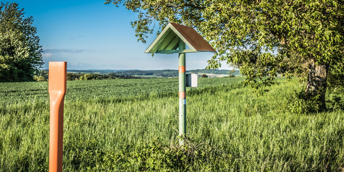What is the purpose of the poles with red roofs near french roads?