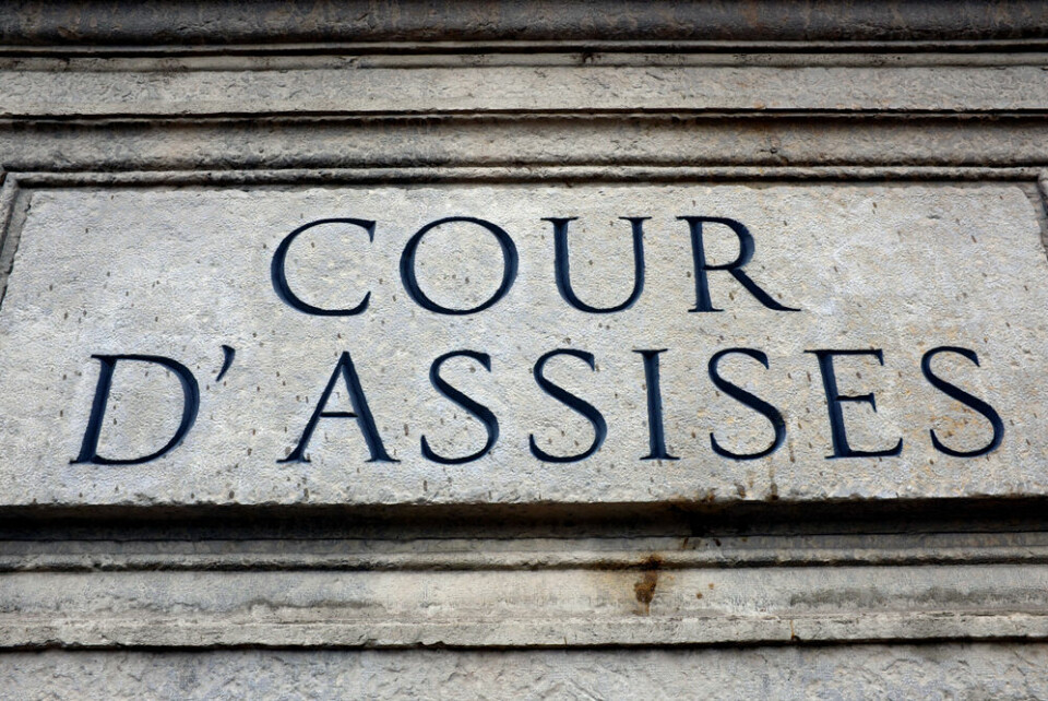 A view of a stone engraving reading Cour d'Assises on a wall
