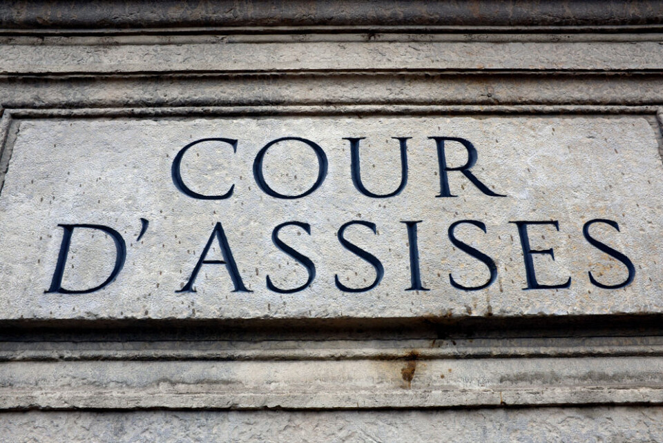 A view of a stone engraving reading Cour d'Assises on a wall