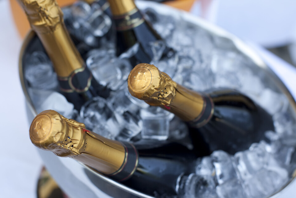 A photo of some unopened Champagne bottles in an ice bucket