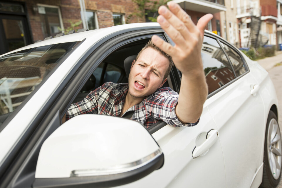 A man shouting out his driving seat car window