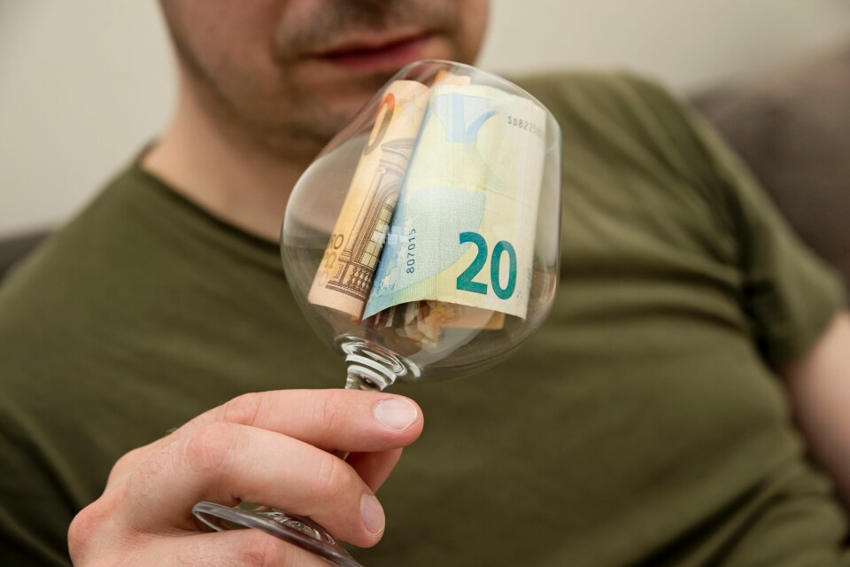 wine glass with euros notes in