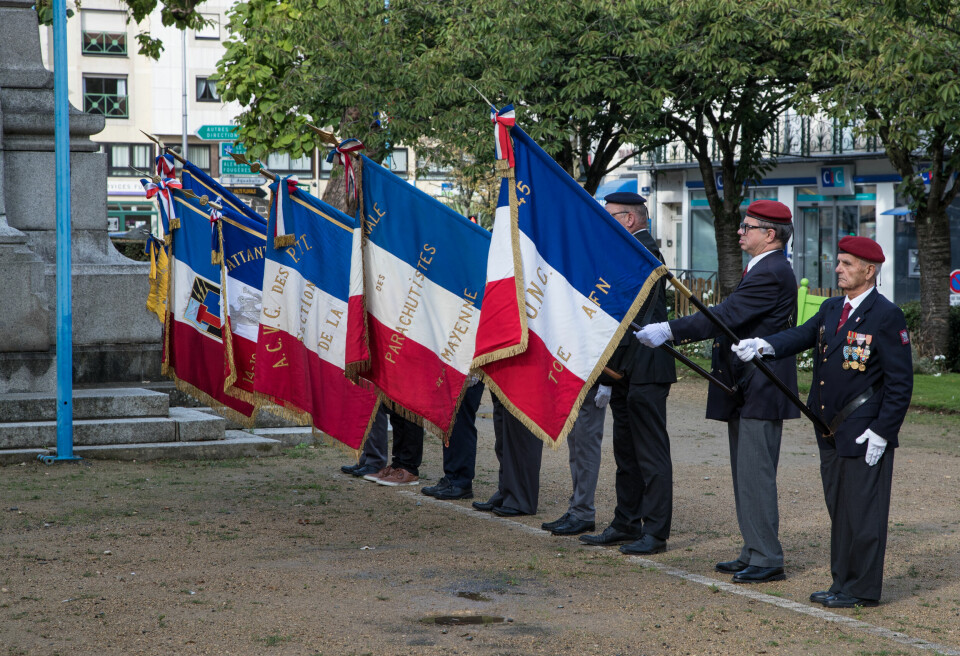 French army veterans hold flags to commemorate the war in Algeria in Laval, western France