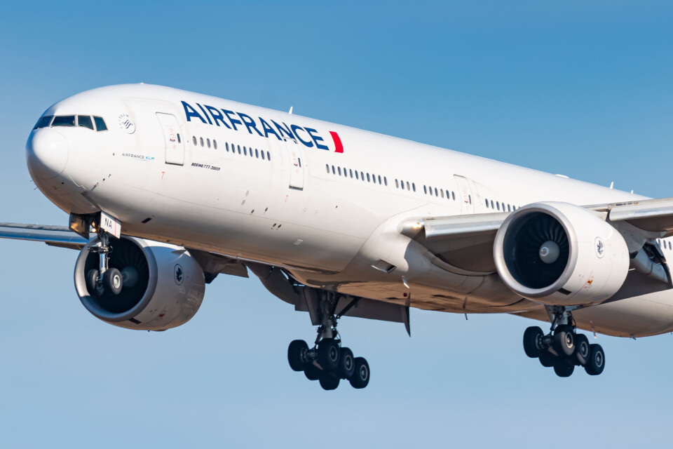 An Air France Boeing 777 with its landing gear showing