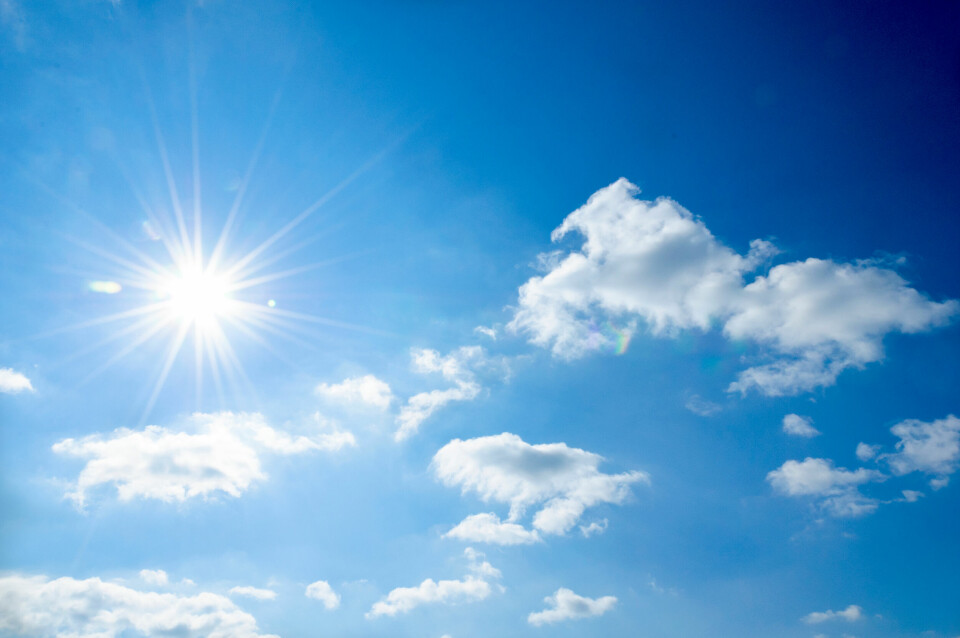 An image of a bright sun in a blue sky