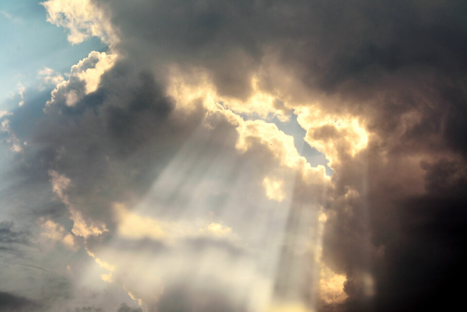 An image of the sun shining through a rain cloud