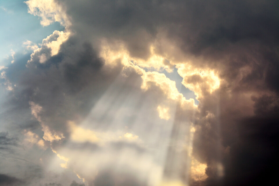 Sebastian_Photography / Shutterstock An image of the sun shining through a rain cloud