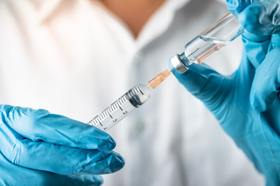 A nurse with a Covid vaccine syringe