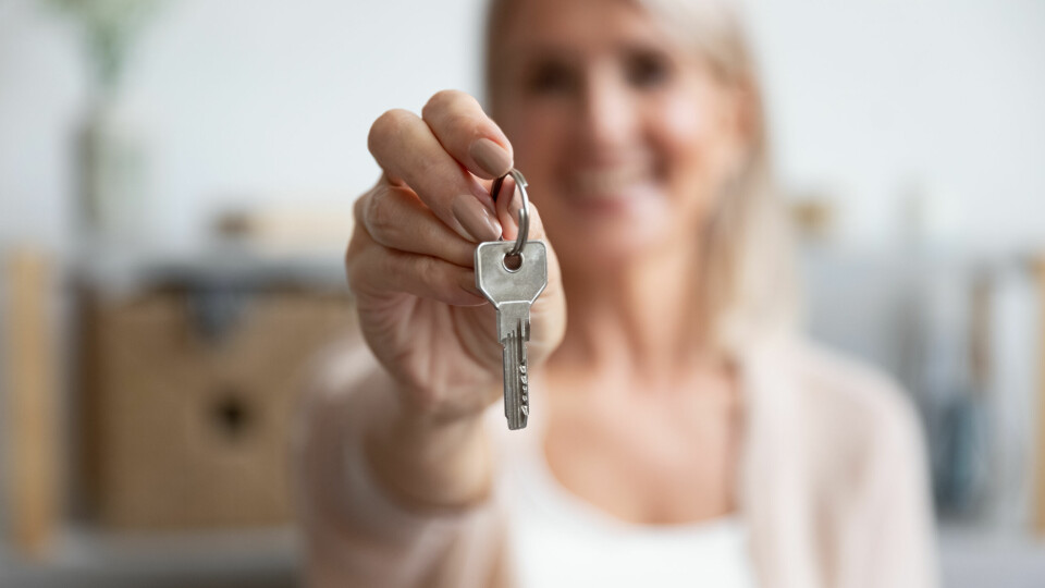 Blurred woman holding out keys