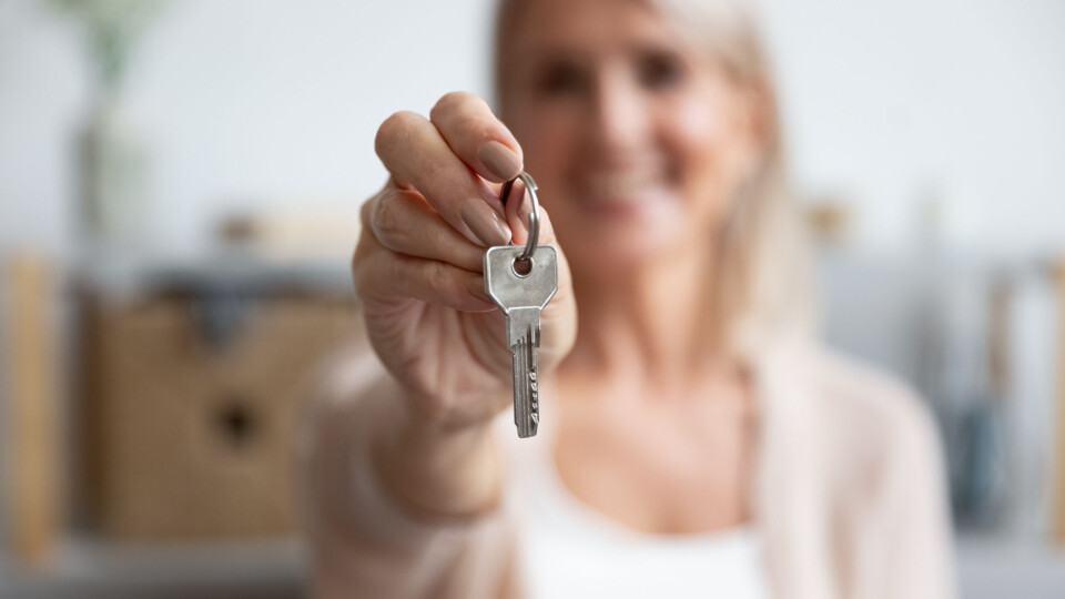 Blurred woman holding out keys