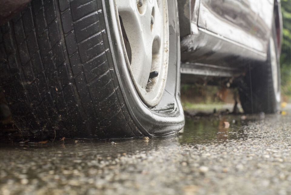 A close-up photo of a flat tyre on a larger car