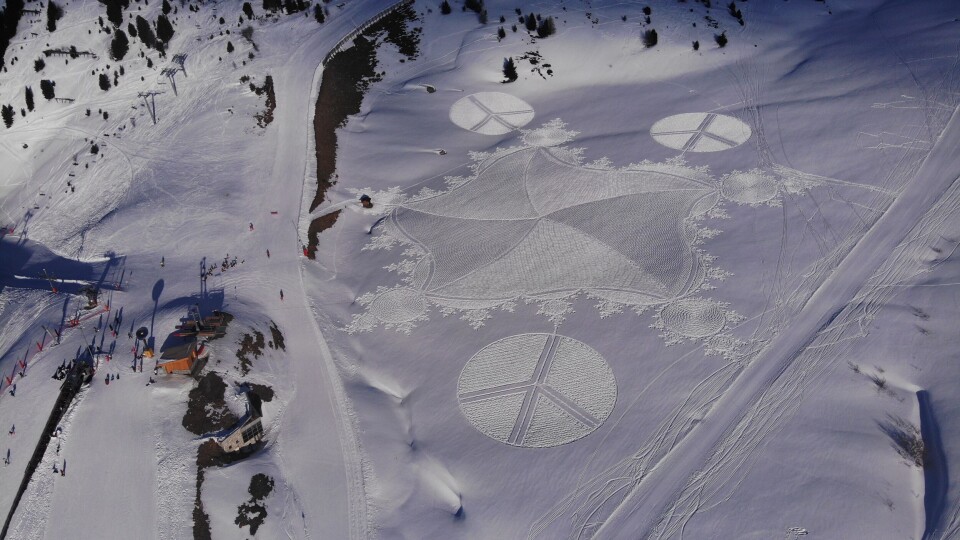 A man walking through snow in raquette snowshoes