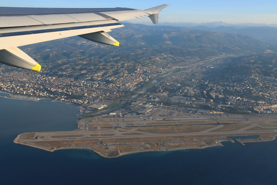 An image of a plane wing with the Mediterranean coastline of Alpes-Maritimes in the background