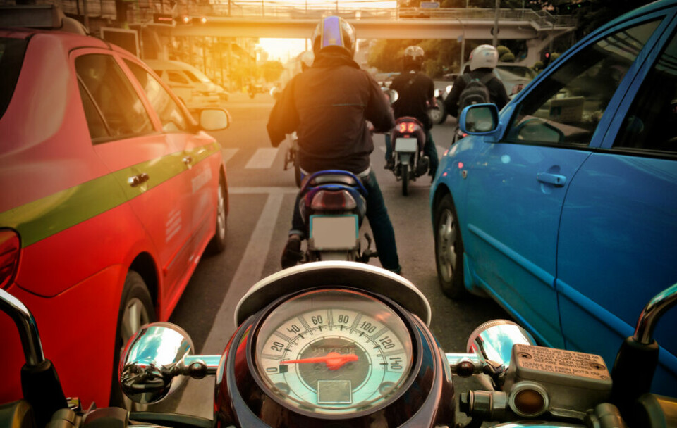 Motorbike travelling between cars. Motorbike lane filtering reintroduced in 21 French departments