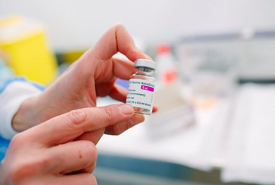 Gencat / Wikimedia Commons Holding vial of AstraZeneca vaccines. People in France age 55+ to continue AstraZeneca vaccination