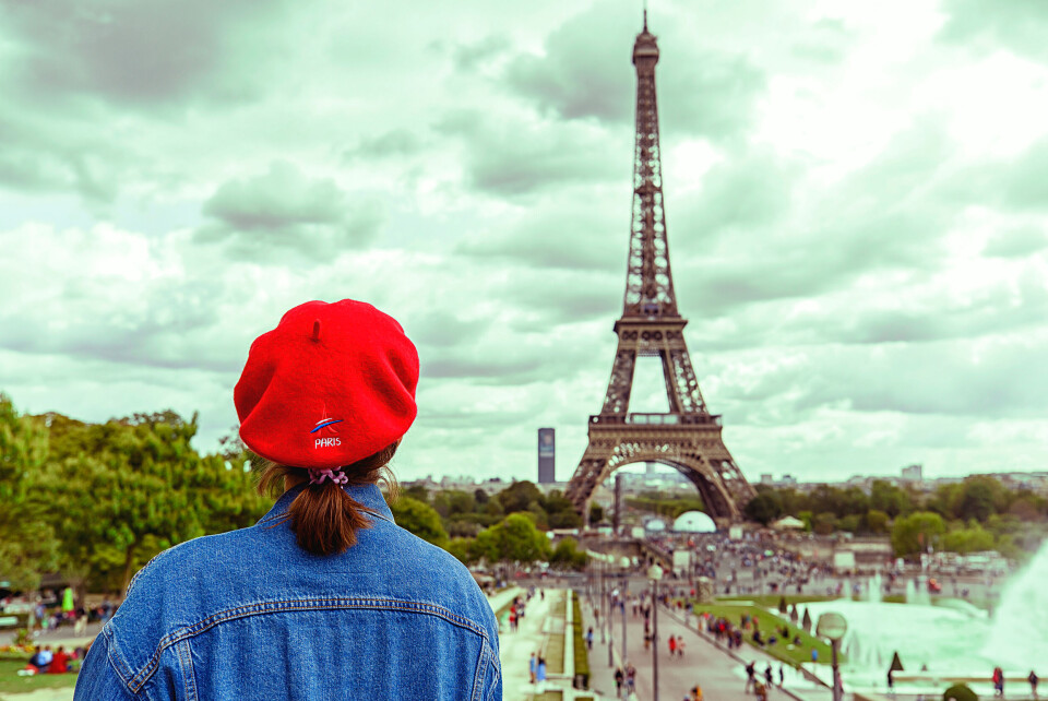 Guzel Gashigullina / Shutterstock A woman looks at the Eiffel Tower in Paris