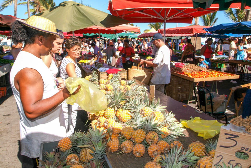 Stefano Ember / Shutterstock People selling and buying food at the market of Saint Paul on La Réunion island