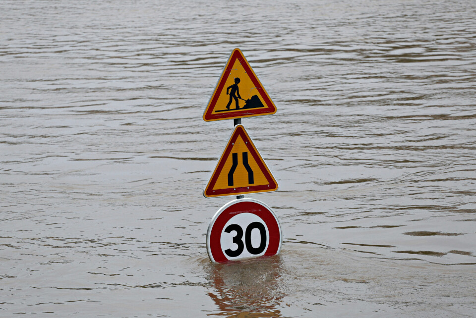 A traffic sign stands in a flooded road in France