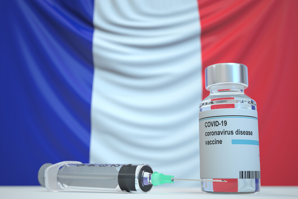 Novikov Aleksey / Shutterstock Covid vaccine vial and syringe with flag of France as a background.