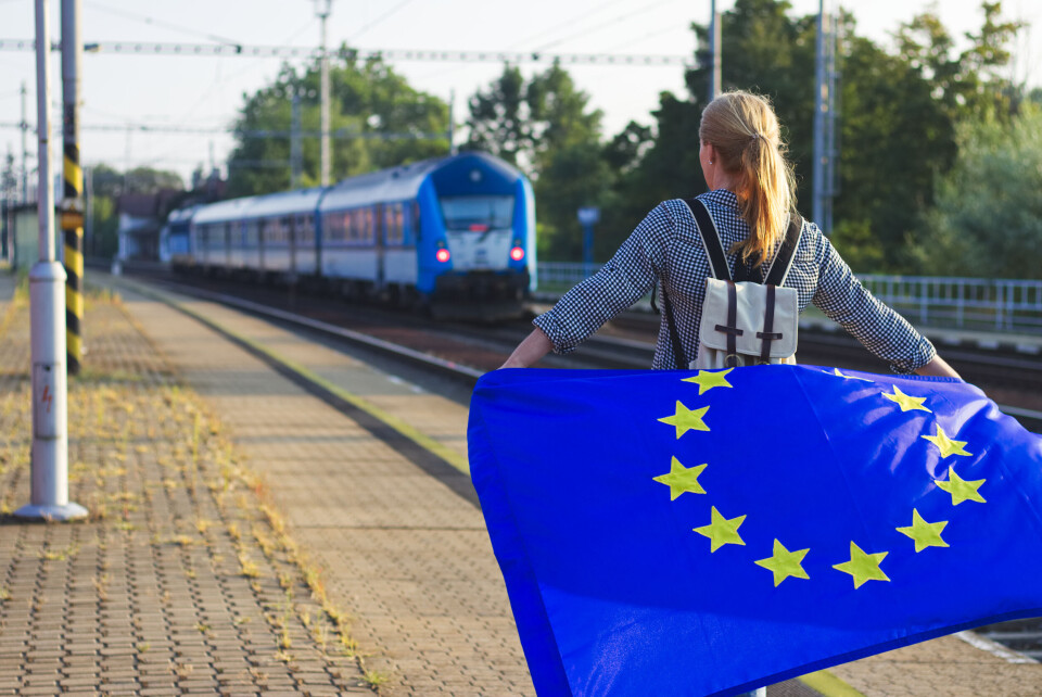 encierro / Shutterstock A person with an EU flag at a train station
