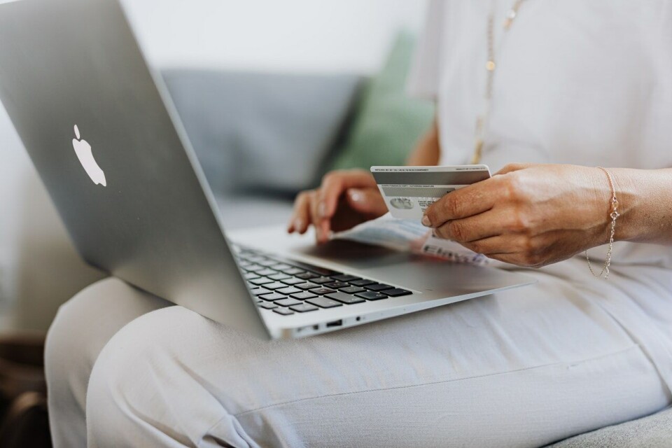 A woman shopping with a credit card online. Victims of credit card fraud in France must be paid back within a day