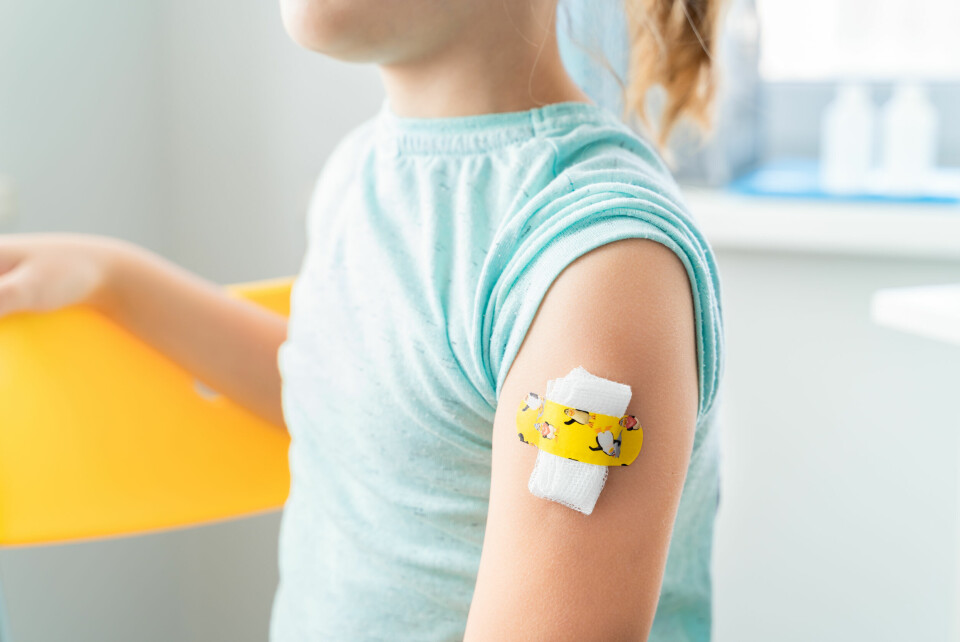 A child with a plaster on their arm after having a vaccination