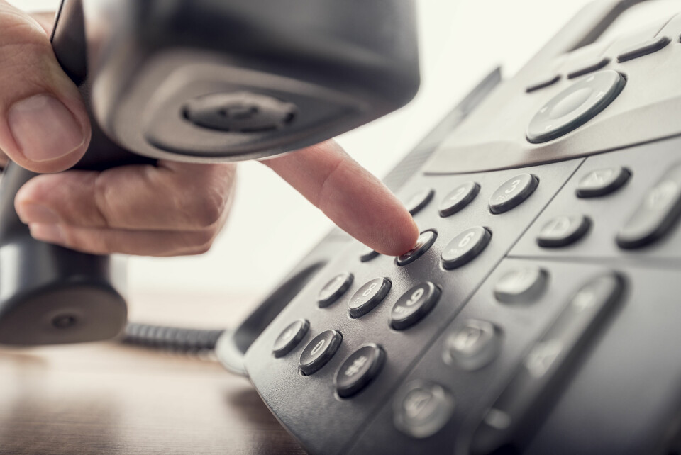 Person making call from landline. New telephone scam costing people in France hundreds of euros