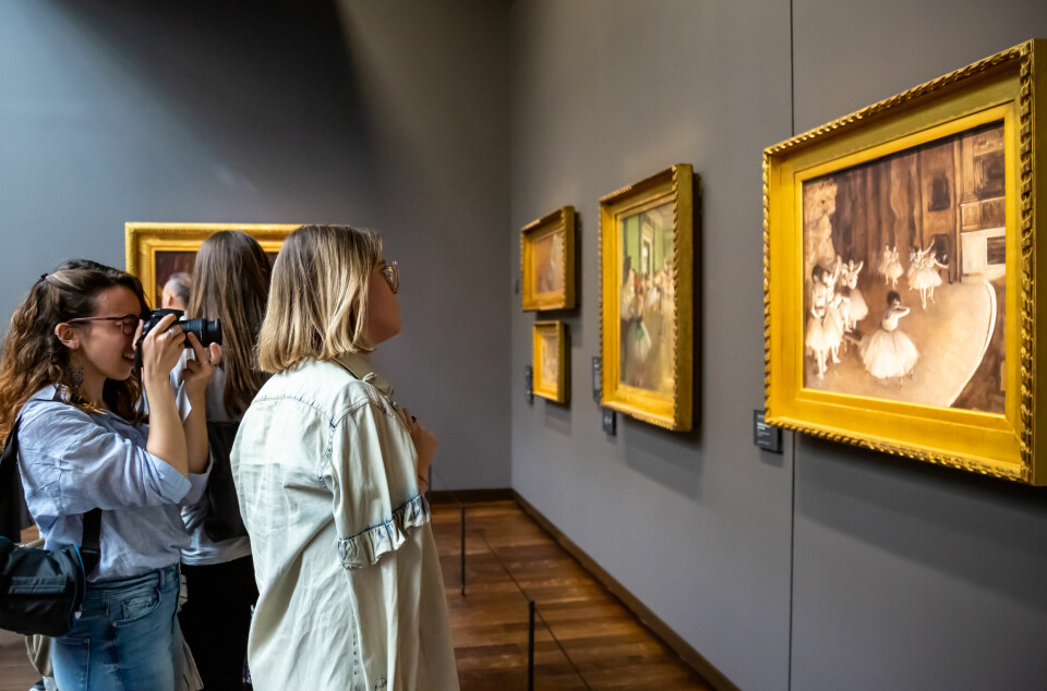 Women looking at a painting in a gallery