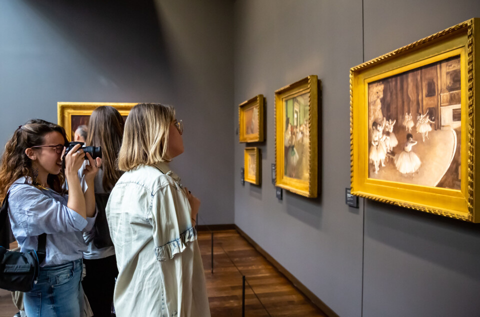 Women looking at a painting in a gallery